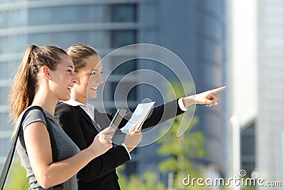 Businesswomen searching location with mobile gps and map Stock Photo