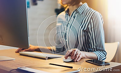 Businesswomen working at office with monitor computer at night, young hipster manager typing on keyboard, female hands texting mes Stock Photo