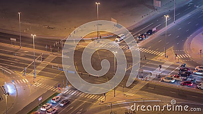 Bussy traffic on the road intersection in Dubai downtown aerial night timelapse, UAE Editorial Stock Photo