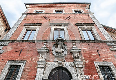 The bust of Gian Gastone de Medici above the impressive entrance of Palazzo Aragazzi Benincasa Stock Photo