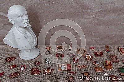 Bust of Lenin and badges with communist symbols Editorial Stock Photo