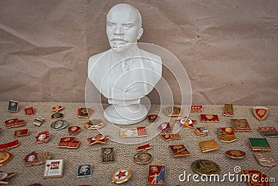 Bust of Lenin and badges with communist symbols Editorial Stock Photo