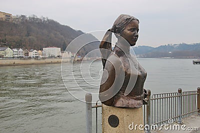 Bust of the poet and landlady Emerenz Meier on the quay of the Danube river in Passau, Germany. Editorial Stock Photo