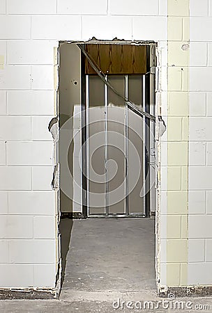 Busted Door In Concrete Wall Stock Photo