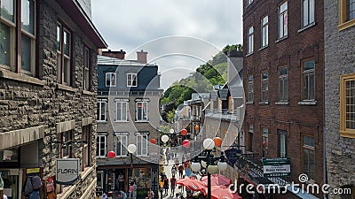 Bustling city street with a group of people walking along the sidewalk. Editorial Stock Photo