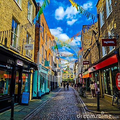 Bustling city street with a variety of shops, restaurants, and pedestrians walking along it. Editorial Stock Photo