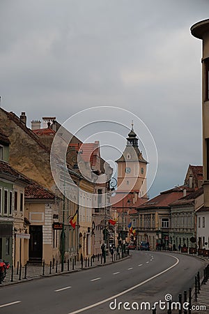 Bustling street featuring a church in the background in Brasov, Romania. Editorial Stock Photo