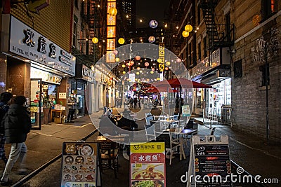 Bustling urban street lined with small shops and eateries in New York, United States Editorial Stock Photo