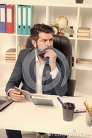 Busy boss in office. Check if i have time today. Man bearded hipster boss sit in leather armchair office interior. Boss Stock Photo