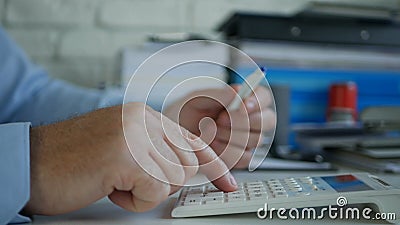 Busy Businessman Making Financial Calculations Using Adding Machine in Accounting Office Stock Photo