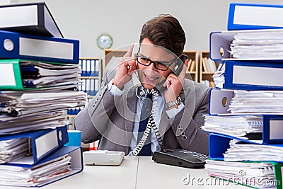 The busy businessman under stress due to excessive work Stock Photo