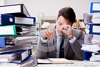 The busy businessman under stress due to excessive work Stock Photo