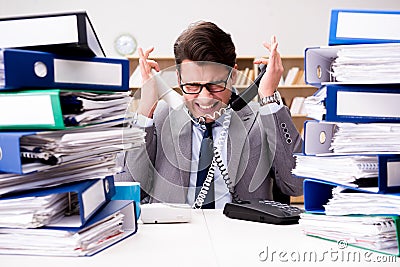 The busy businessman under stress due to excessive work Stock Photo