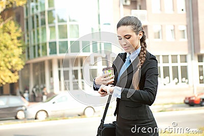 Busy businesswoman checking the time Stock Photo