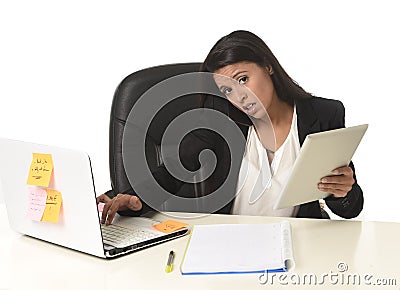 Busy businesswoman suffering stress working at office computer desk worried desperate Stock Photo
