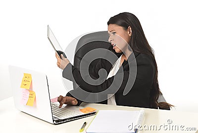 Busy businesswoman suffering stress working at office computer desk worried desperate Stock Photo