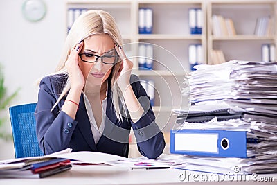 The busy businesswoman working in office at desk Stock Photo