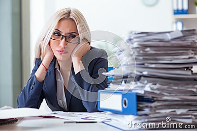 The busy businesswoman working in office at desk Stock Photo