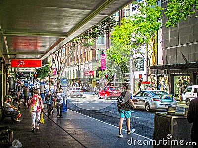 Busy Colorful Downtown CBD streets with man people walking on sidewalks Editorial Stock Photo
