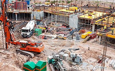 Busy construction site with machinery and workers Editorial Stock Photo