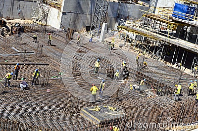 Busy construction site, with workers and heavy machinery Editorial Stock Photo
