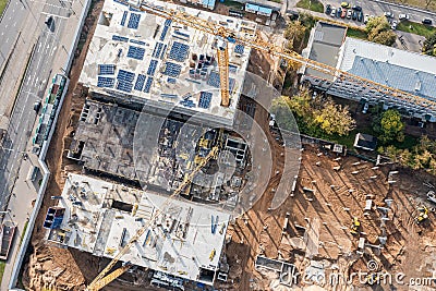 Busy construction site with working cranes and machines for earthwork. aerial top view Stock Photo
