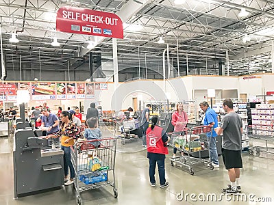 Busy customers at self-checkout kiosks area of Costco in Churchill Way, Dallas Editorial Stock Photo