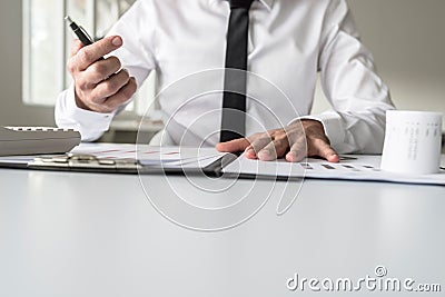 Busy financial adviser working at his business desk with many do Stock Photo