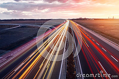 Busy highway with fast moving vehicles in beautiful sunset Stock Photo