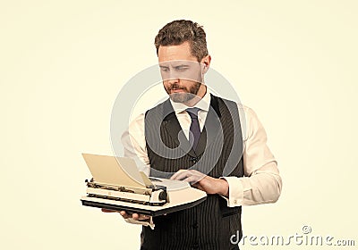 busy man typing on vintage typewriter. businessman with retro typewriter. typist author Stock Photo