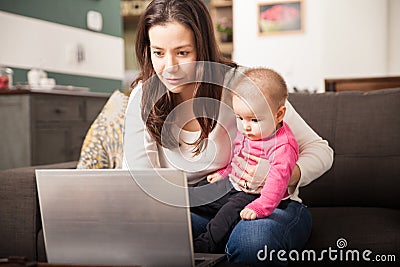 Busy mom working at home Stock Photo