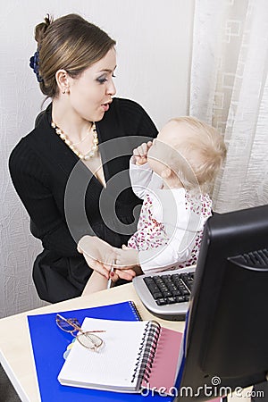 Busy mother with her baby Stock Photo