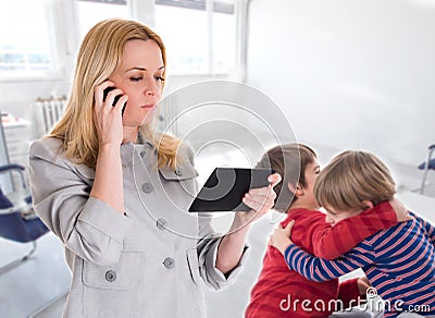 Busy mother with tablet and mobile while her child Stock Photo