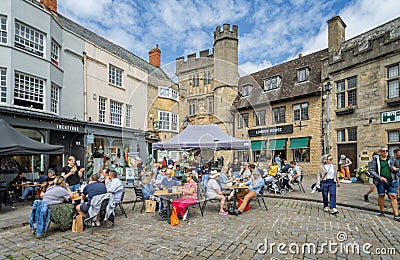 Busy outdoor cafes in front of the Penniless Porch in Market Place, Wells, Somerset, UK Editorial Stock Photo