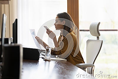 Busy professional woman negotiating on startup project financial report Stock Photo