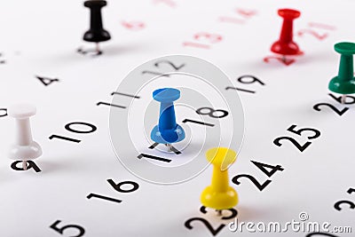 Busy schedule - colorful pins on a calendar Stock Photo