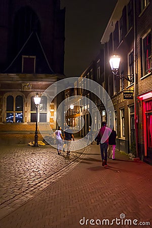 The busy sidewalks and pedstrian zones in the Red Light District by night - AMSTERDAM - THE NETHERLANDS - JULY 20, 2017 Editorial Stock Photo