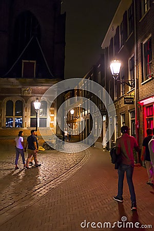 The busy sidewalks and pedstrian zones in the Red Light District by night - AMSTERDAM - THE NETHERLANDS - JULY 20, 2017 Editorial Stock Photo