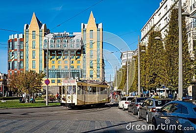 Busy street in the center of Antwerp with old tram and parked taxi cars, exterior of iconic Radisson Blu hotel in the background Editorial Stock Photo