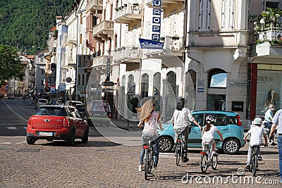 Busy street in Merano, Italy after lock-down. Bicyclists and cars in May of 2020 on Theatre Square. Editorial Stock Photo