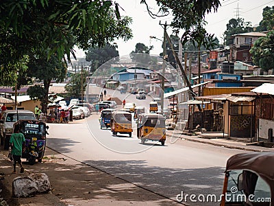 Busy street and residential buildings of central Monrovia in Liberia Editorial Stock Photo