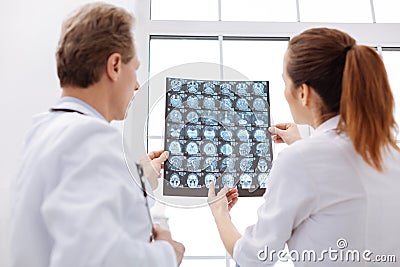 Busy surgeon asking his colleague for consultation Stock Photo