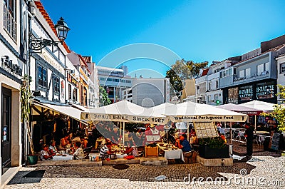 Busy touristic restaurants and bars area in the center of Cascais with traditional Portuguese architecture Editorial Stock Photo