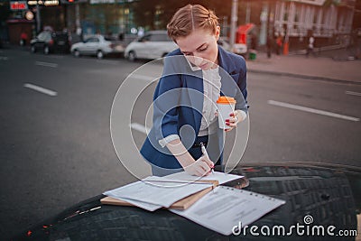 Busy woman is in a hurry, she does not have time, she is going to talk on the phone on the go. Businesswoman doing Stock Photo
