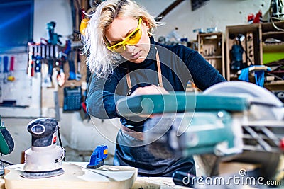 Busy wood designer in a small carpentry workshop Stock Photo