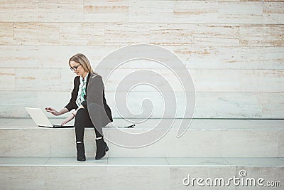 Busy young business woman talking on her mobile phone Stock Photo