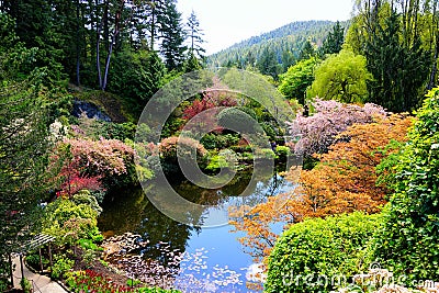 Butchart Gardens, Victoria, Canada, pond with vibrant spring flowers Stock Photo