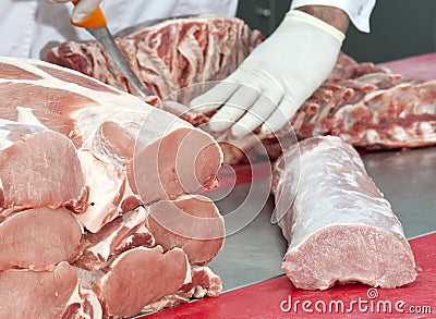 Butcher cutting pork meat Stock Photo