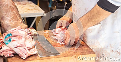 Meat concept. Butcher hands are cutting with cleaver ribs of lamb, sheep Stock Photo