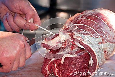 Butcher tying meat Stock Photo